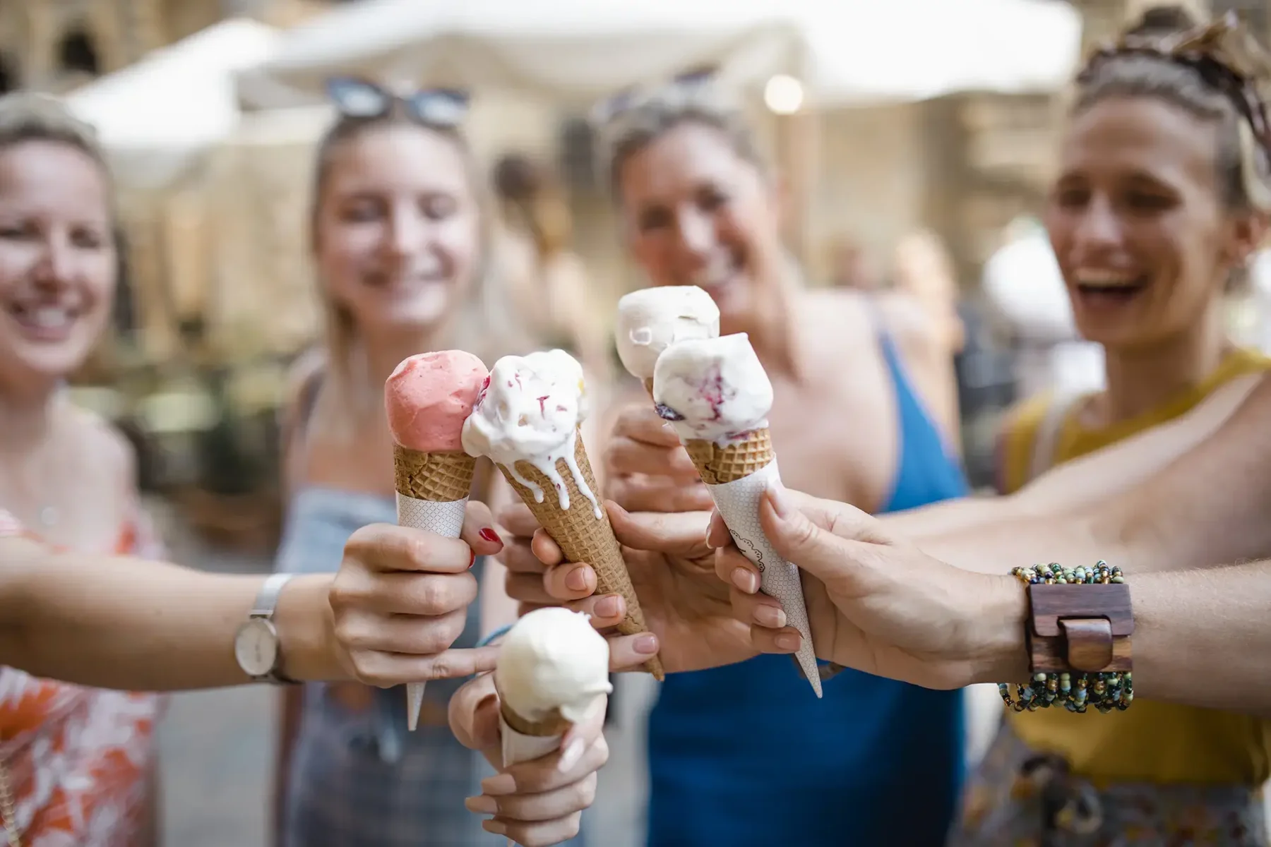 Friends at an outdoor market with ice cream cones